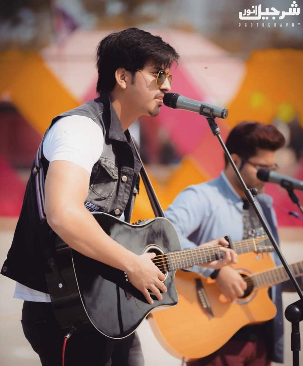 Mubashir Zaman performing live with an acoustic guitar