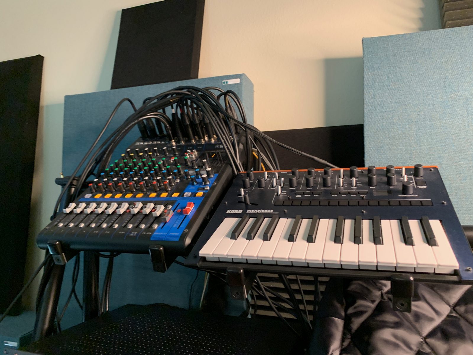Mixer and keyboard controller surrounded by cables in the studio